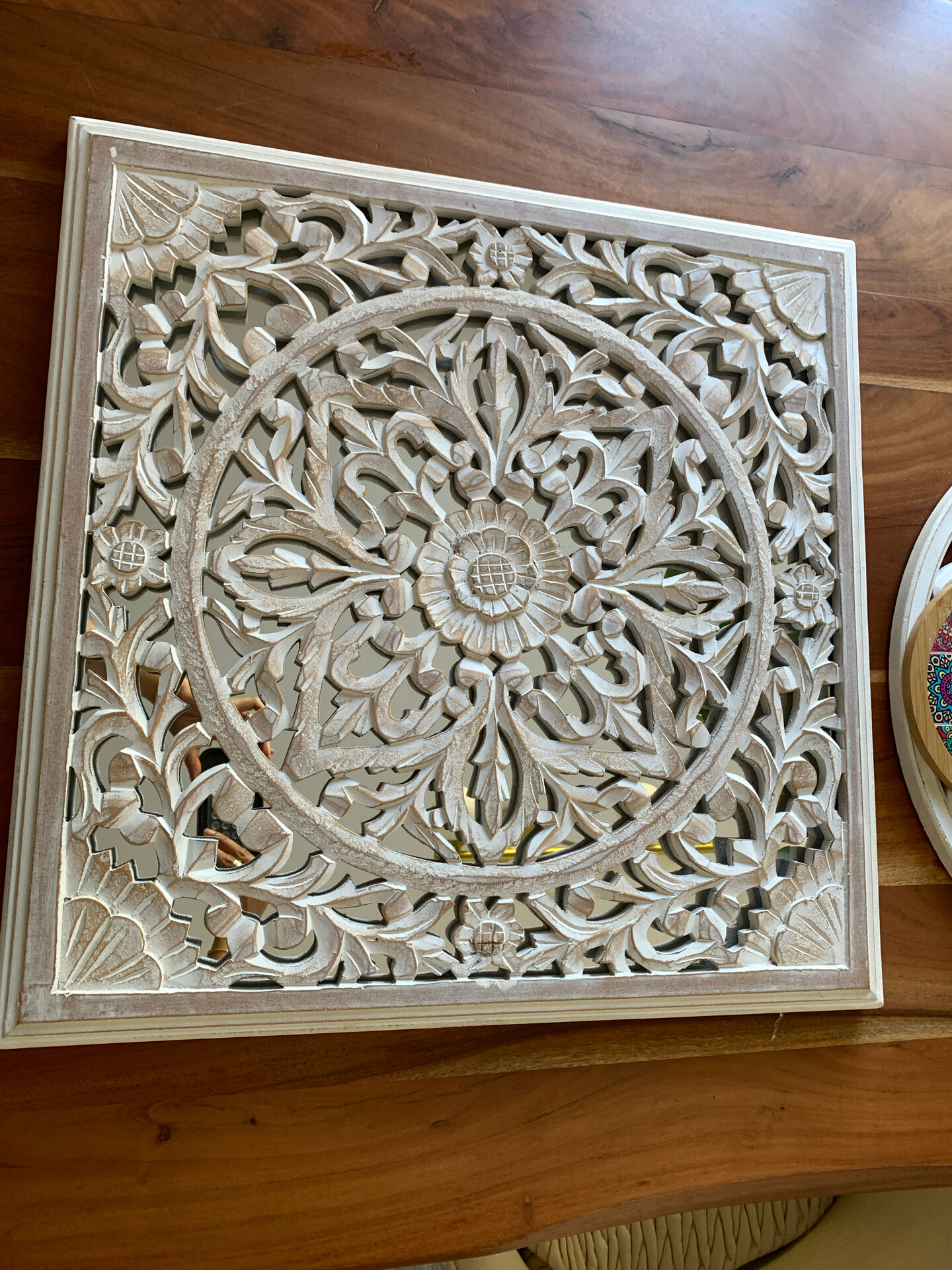 Magnificent carved frame with an interior mirror made of mango wood.