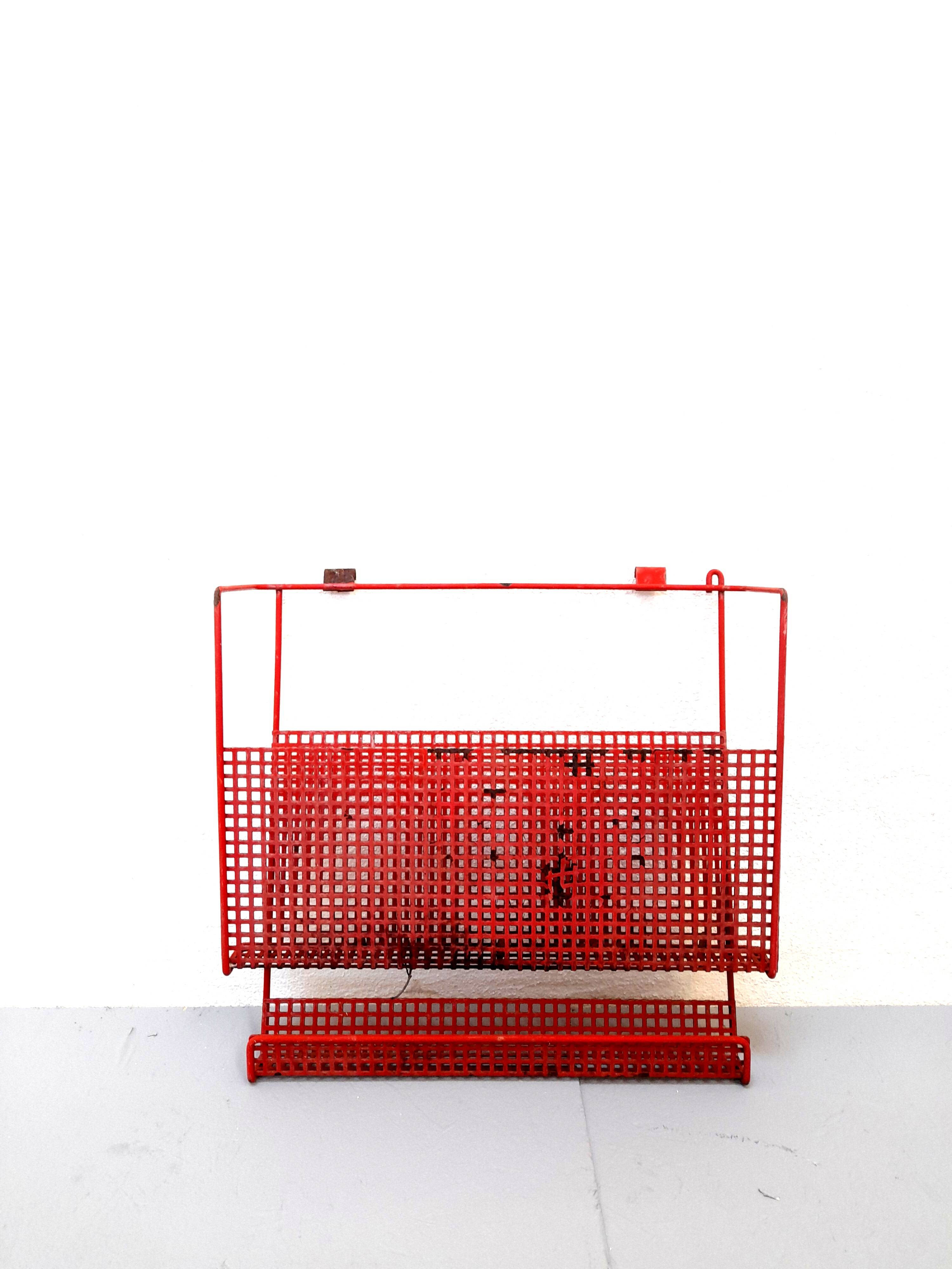 Vintage magazine rack in red lacquered perforated metal from the 70s