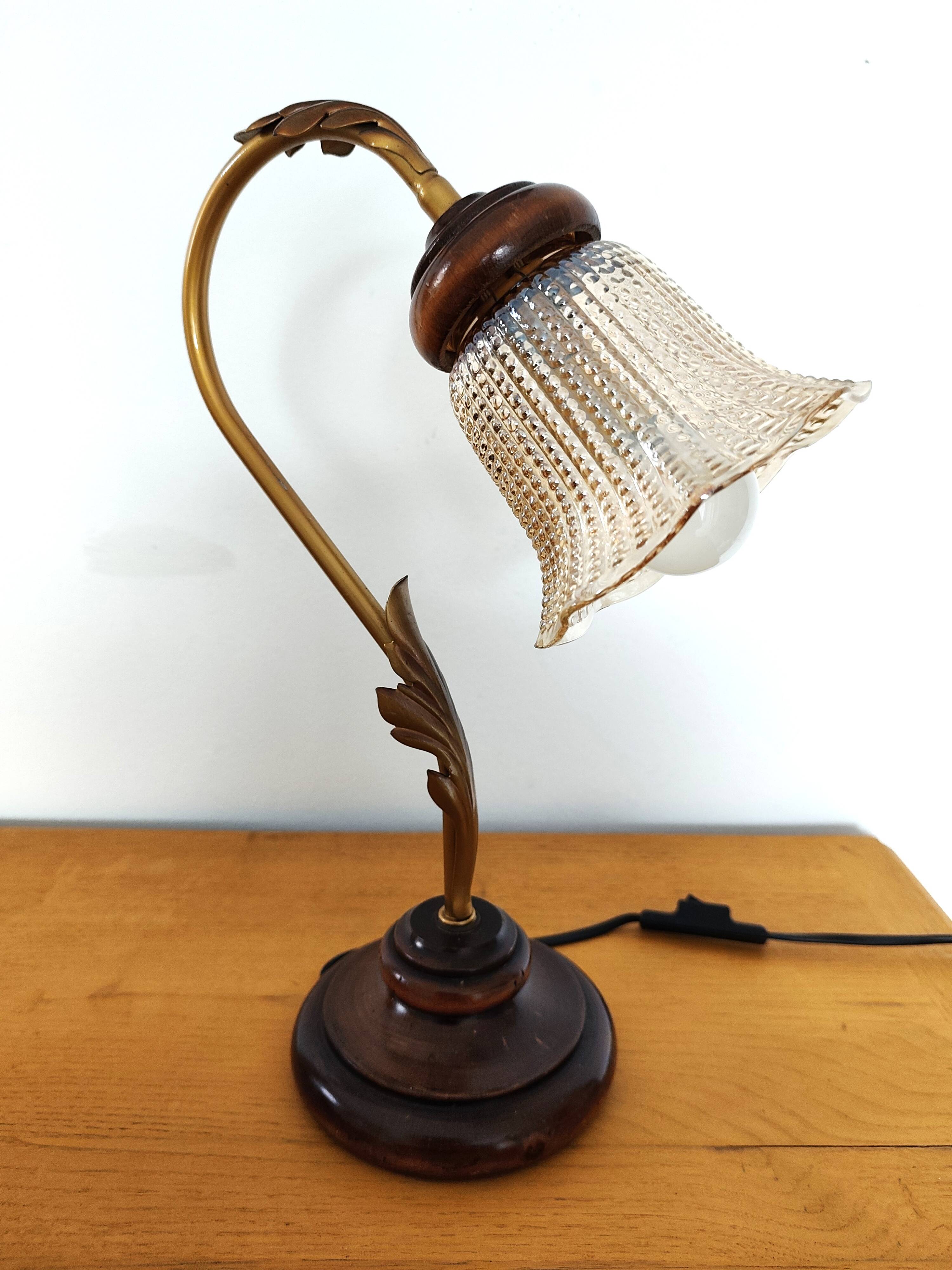 Gold swan neck table lamp with amber tulip glass.