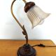 Gold swan neck table lamp with amber tulip glass.