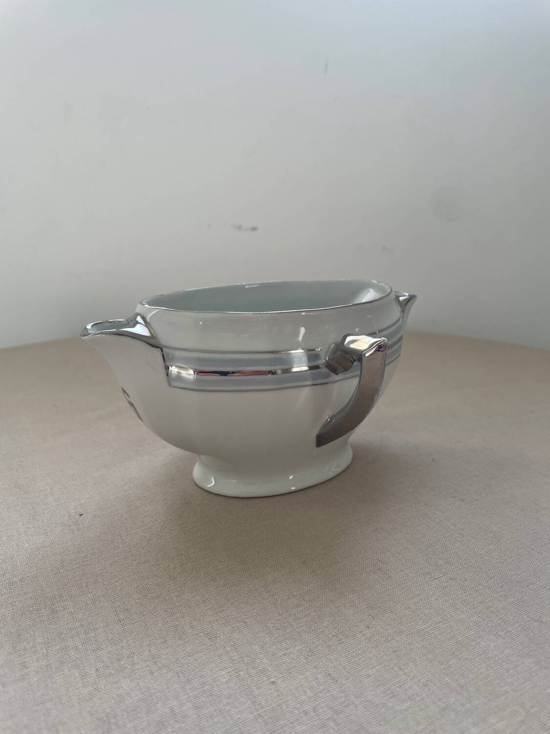 Antique white French porcelain sauce boat M&S with silver trim.