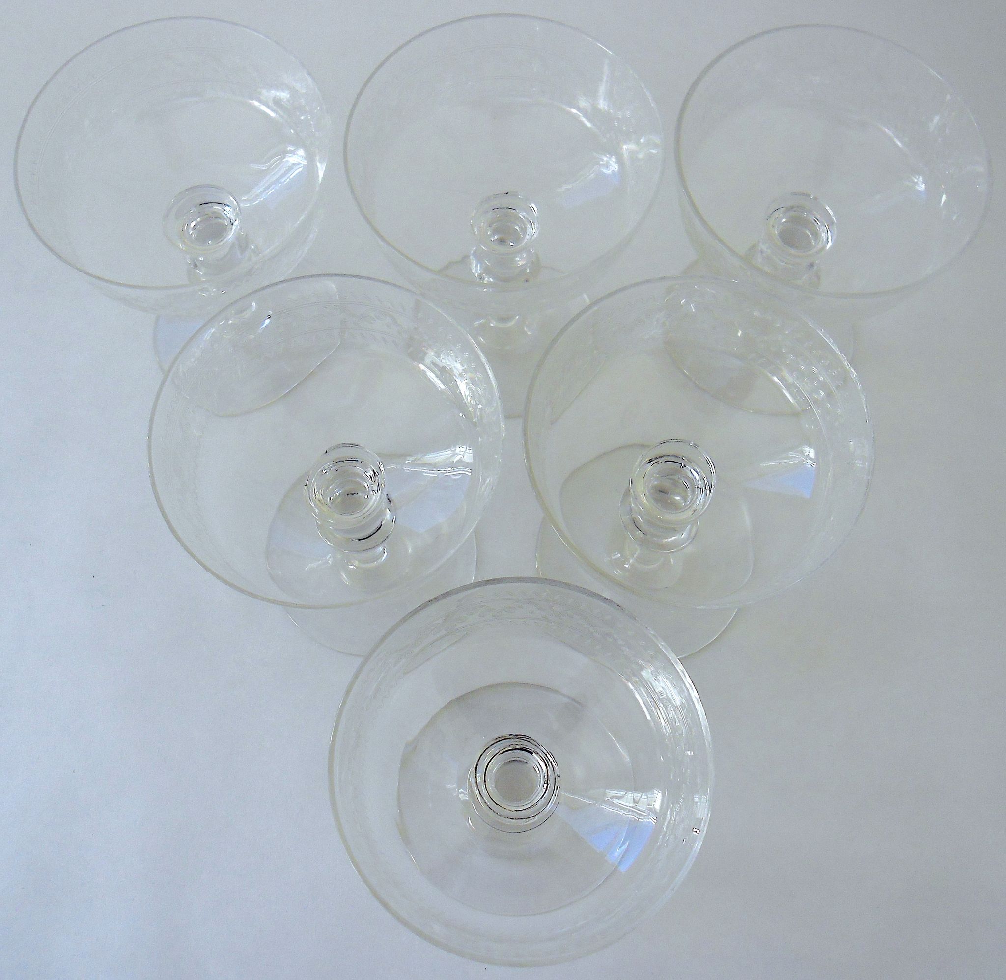 Suite of six champagne glasses on foot in engraved colorless crystal