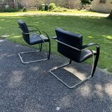2 black cantilever armchairs