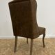 Upholstered armchair in brown imitation leather