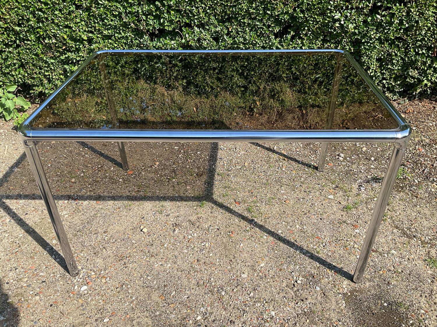 70s dining table in tubular chrome metal and smoked glass