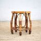 Vintage bamboo stool, woven rattan plant stand, interior decoration.