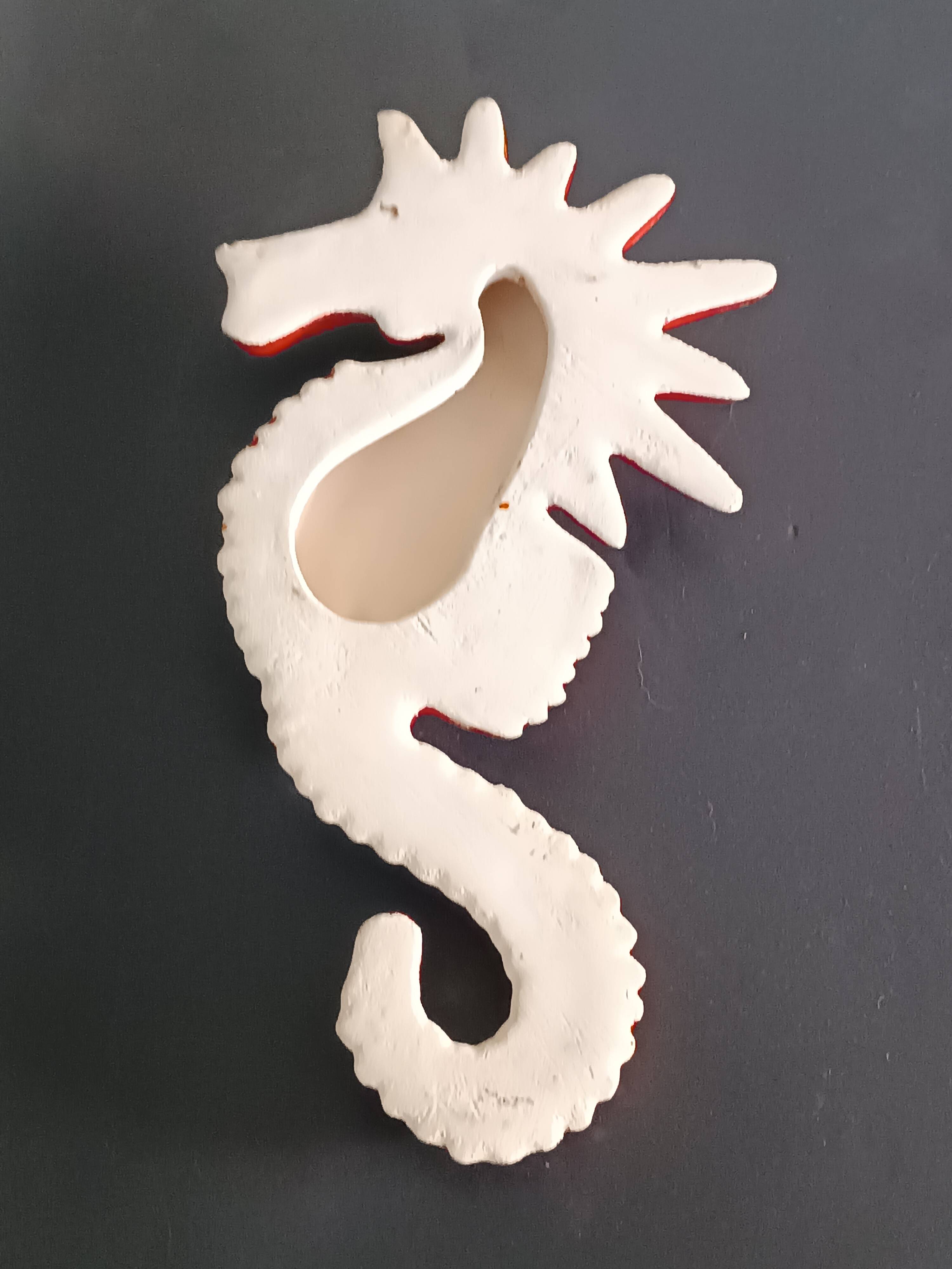 Two vintage ceramic wall pots featuring a seahorse and a starfish.