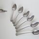 Serving small silver metal notched spoons
