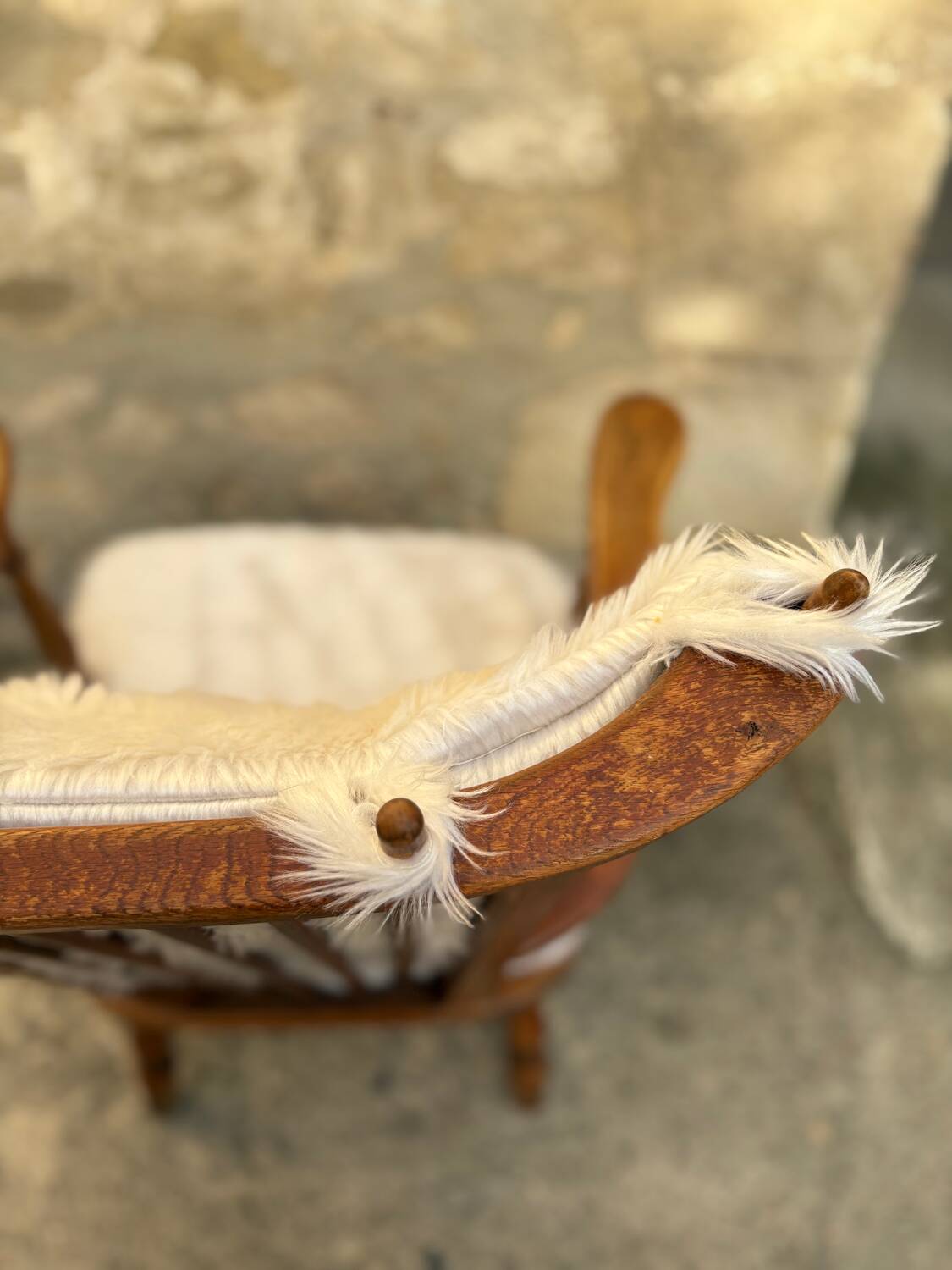 Scandinavian armchair in solid wood with beige fur cushion