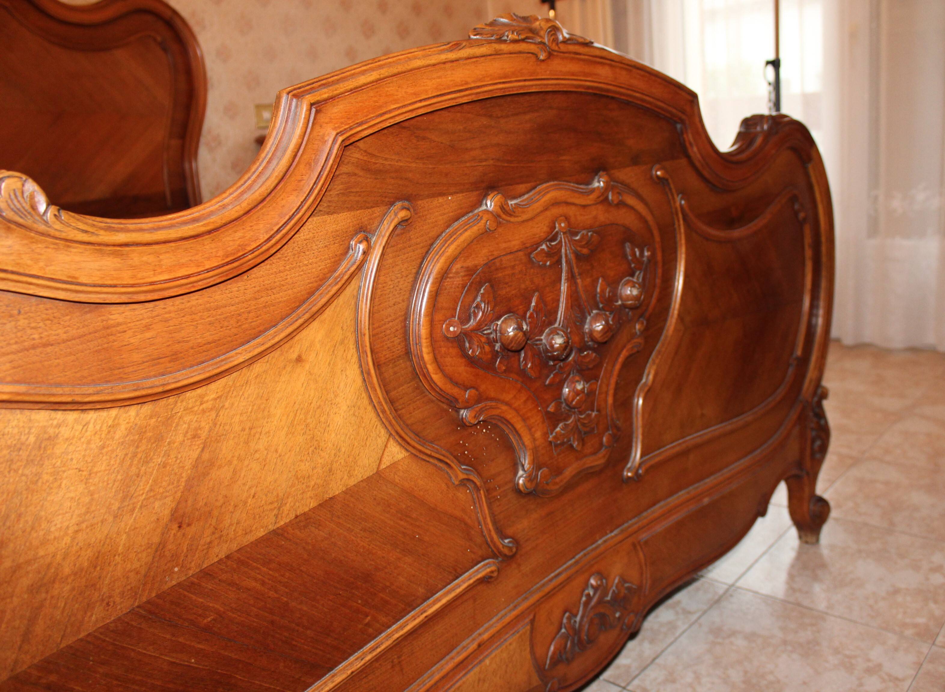 Walnut rocaille bed from the early 20th century.