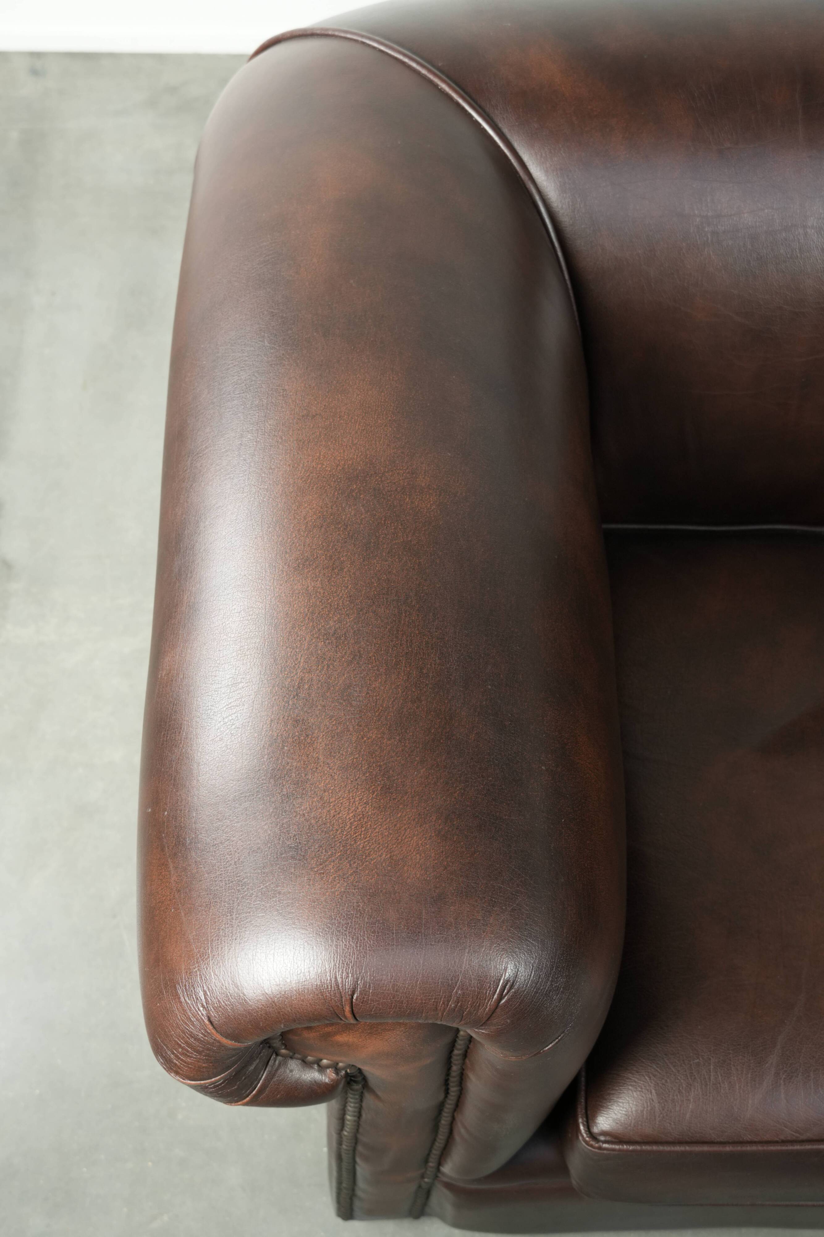 Set of a smooth chesterfield sofa and armchair with a timeless English look