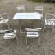 Garden furniture in wrought iron and wooden slats composed of two armchairs, 4 chairs and a table.
