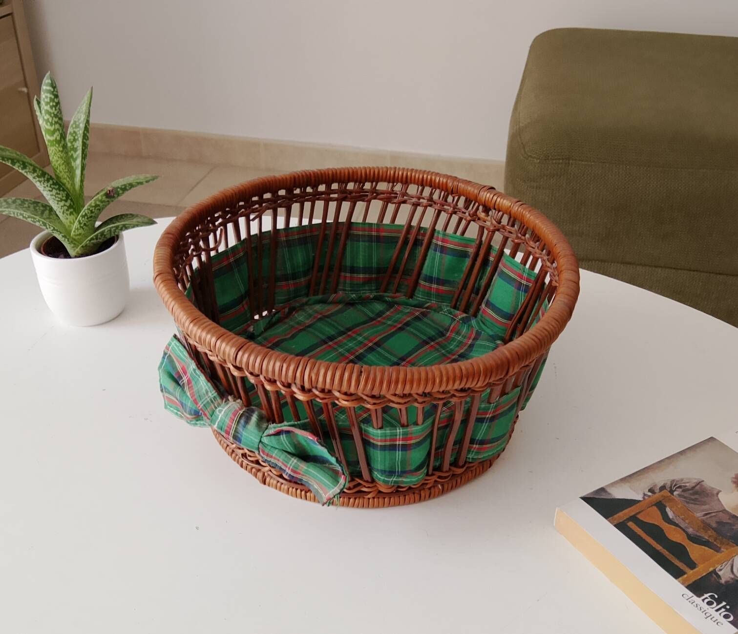 Vintage wicker and rattan basket with tartan fabric.