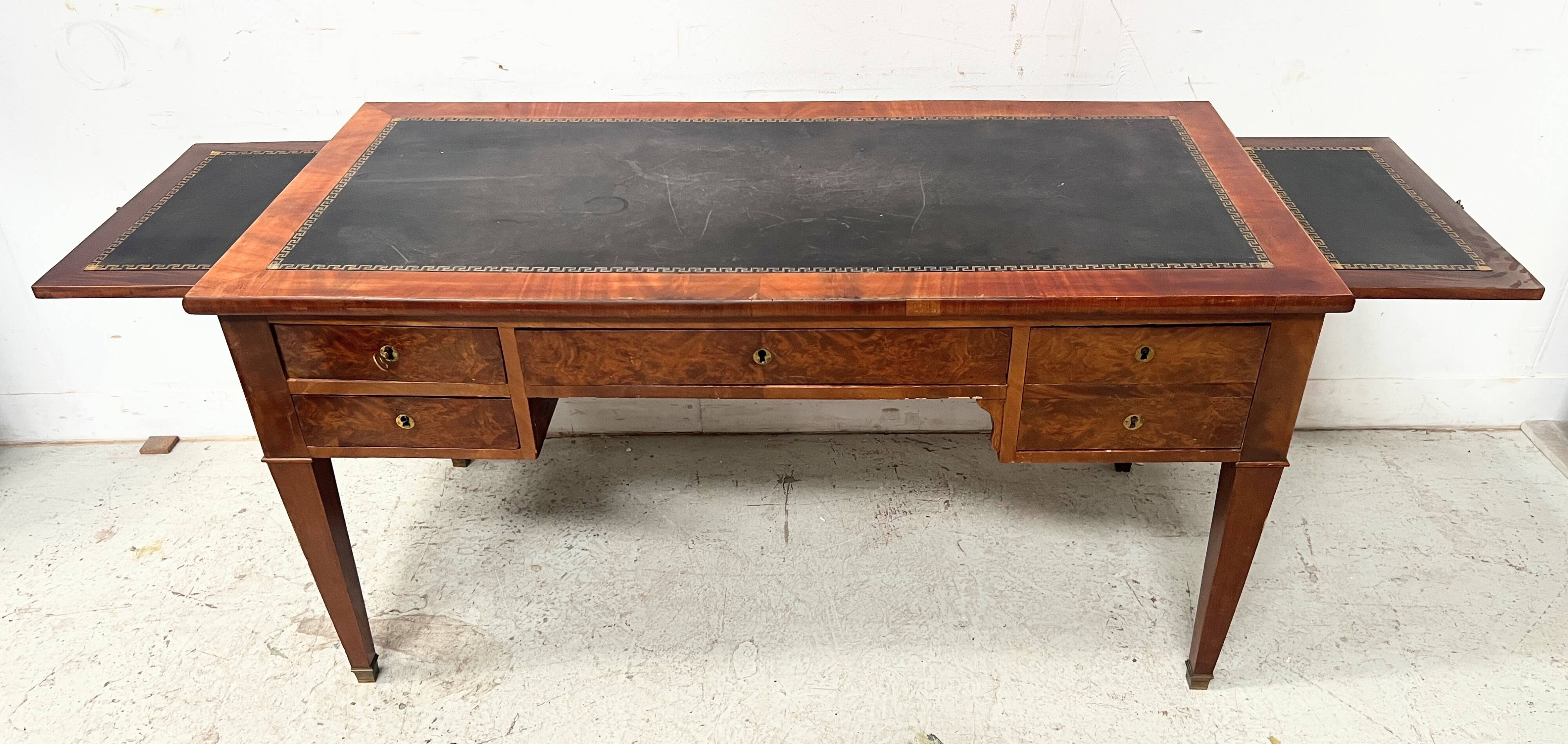 Louis XVI style flat desk in walnut and veneer, 19th century.