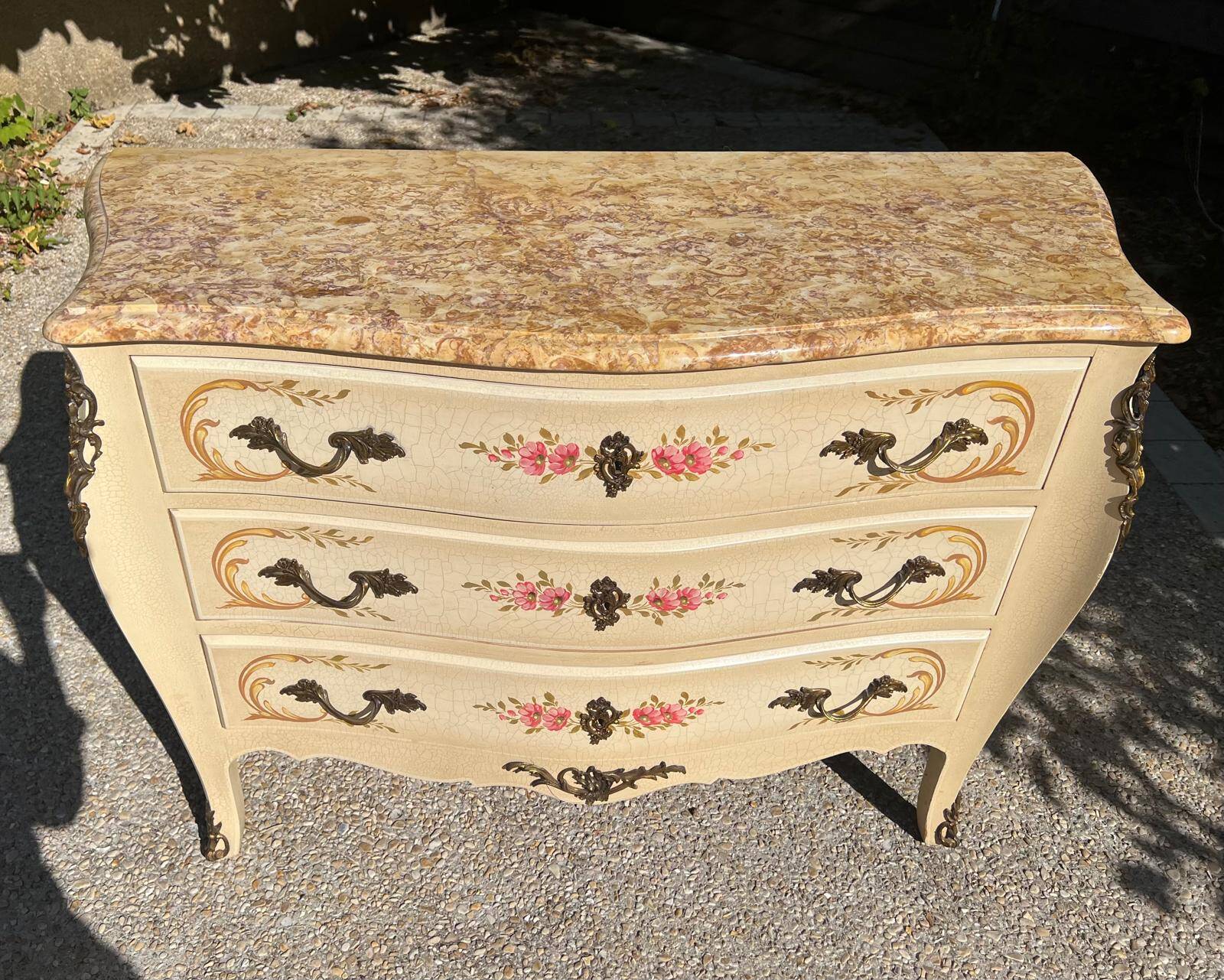 Curved Louis XV style commode in marble with painted floral decoration.