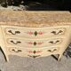 Curved Louis XV style commode in marble with painted floral decoration.