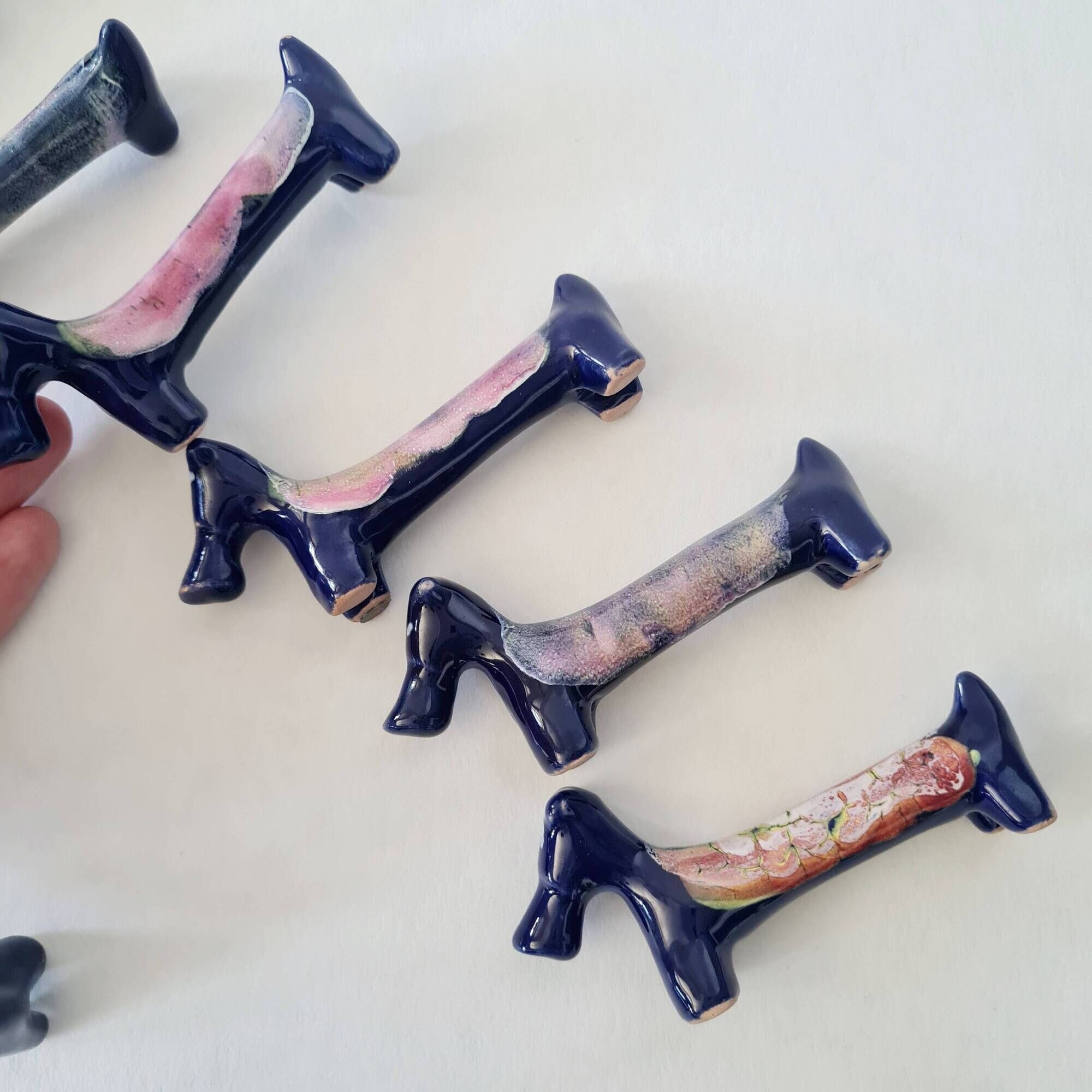 Set of 8 vintage ceramic knife rests, retro dog design.
