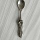 Antique small spoons with a metal bow design