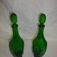 Set of 2 vintage green glass faceted carafes with stoppers.