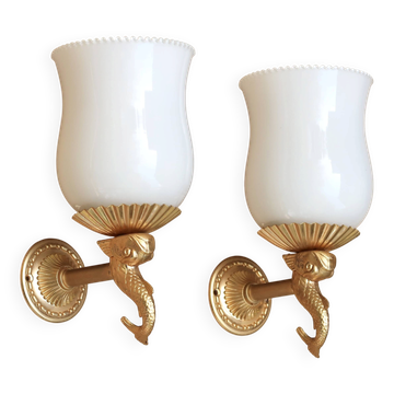 Pair of gold metal and opaque glass wall lights adorned with fish from the 1950s.