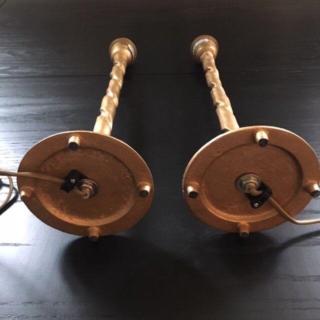 Pair of feet of golden lamps