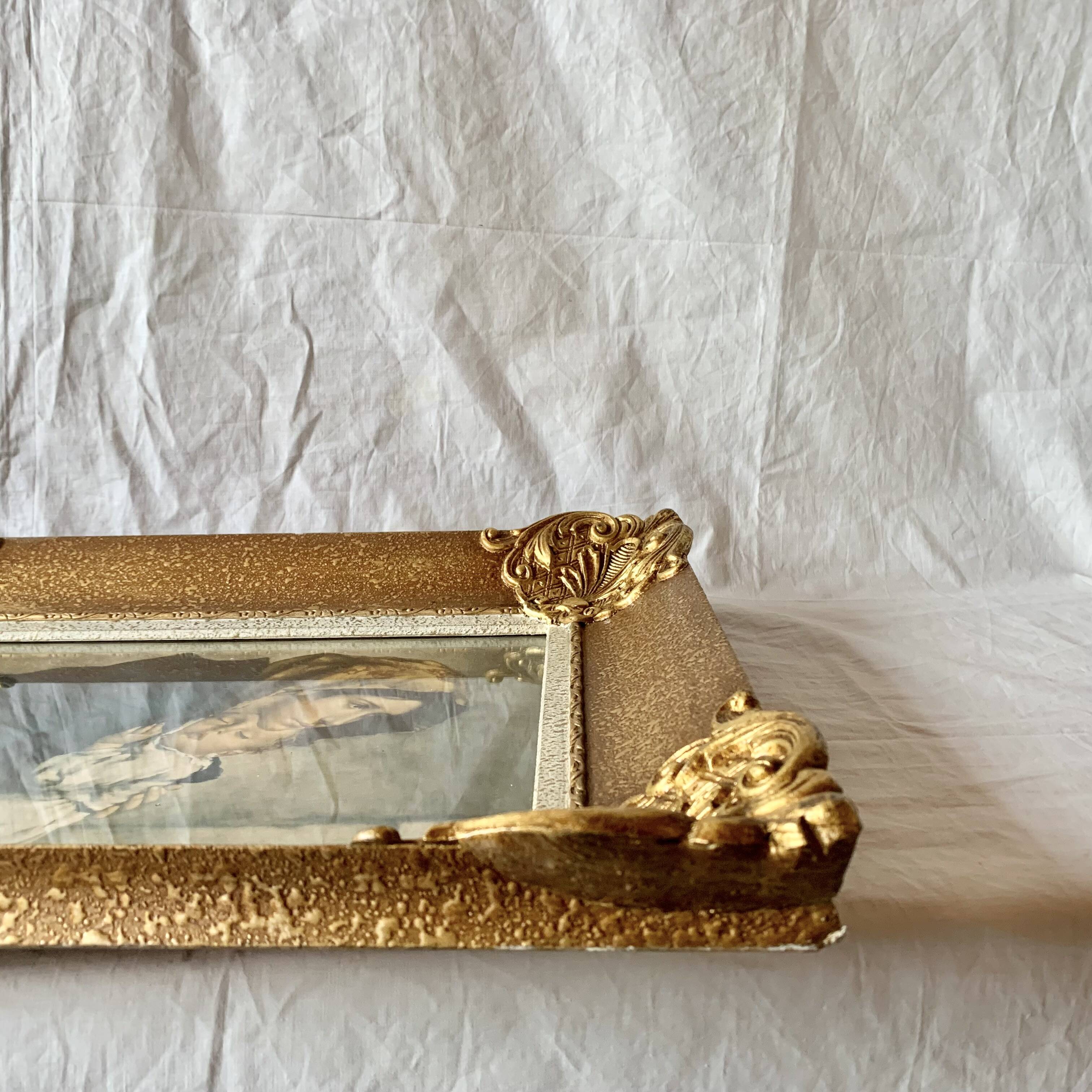Old wall frame in carved gilded wood