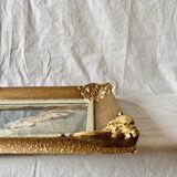 Old wall frame in carved gilded wood