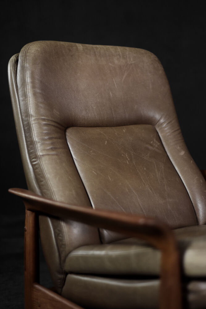 High teak and brown leather armchair with reclining backrest, mid-century Danish style, 1960s.