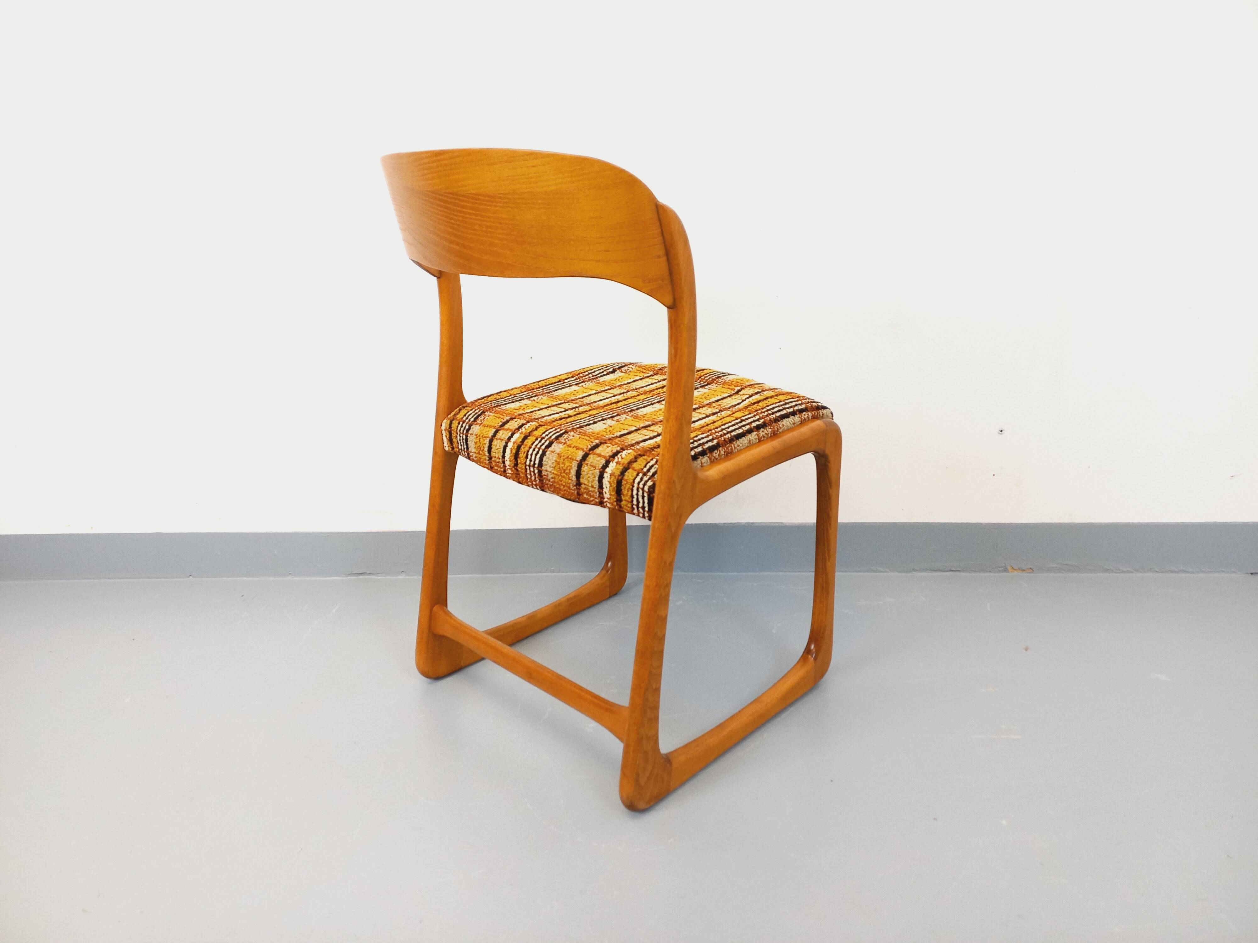 Vintage sled chair by Baumann in wood and wool fabric.