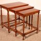 Nested tables in satin wood with brass inlays.