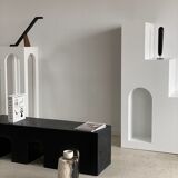 Black solid monoxyl wood bench carved into 3 arches