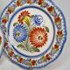 Pair of Henriot Quimper plates decorated with flower, 24 cm