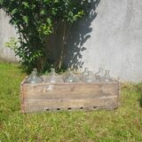 old wooden crate with 10 glass bottles