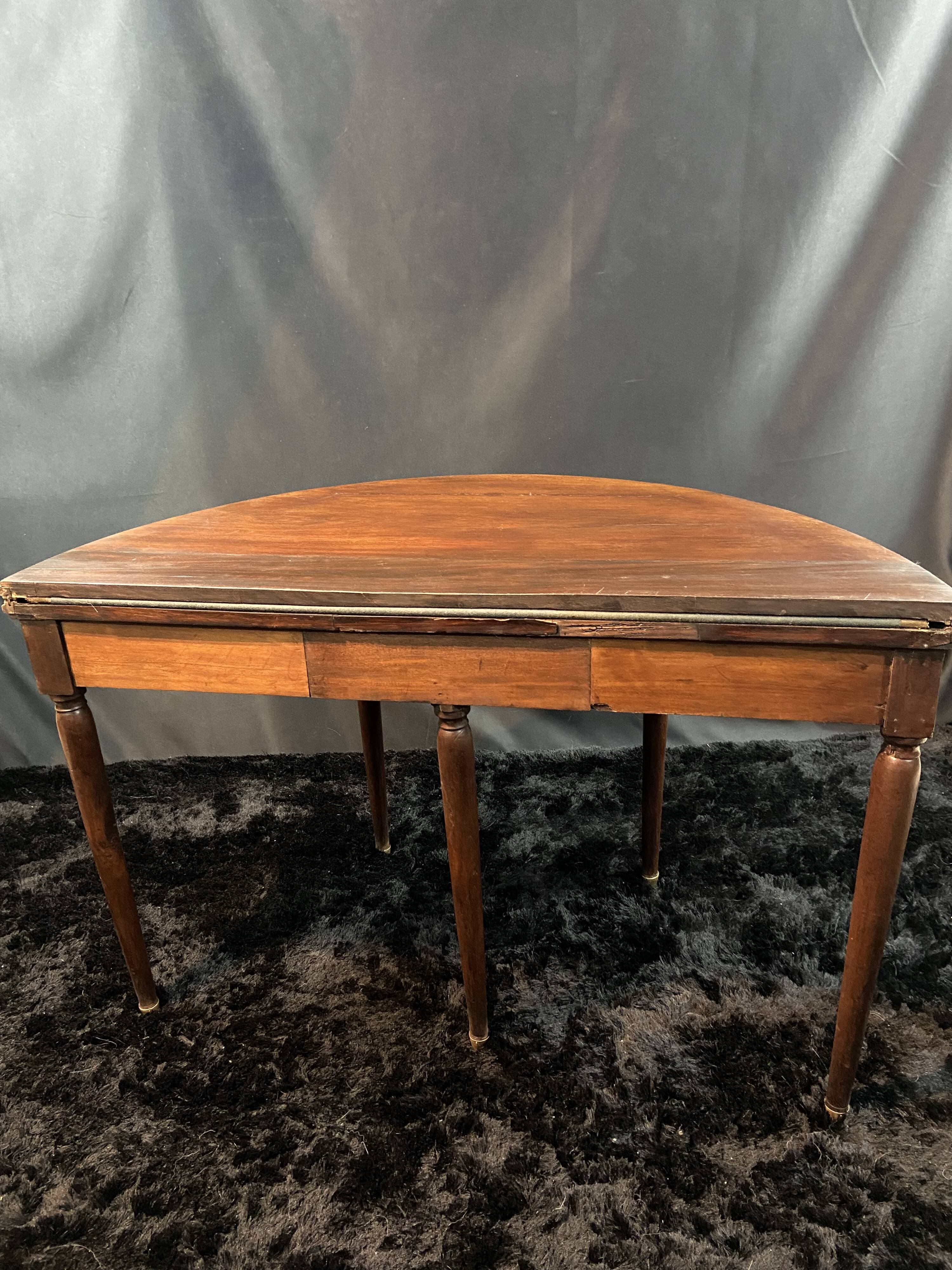 A Louis XVI period mahogany half-moon table forming a console/games table