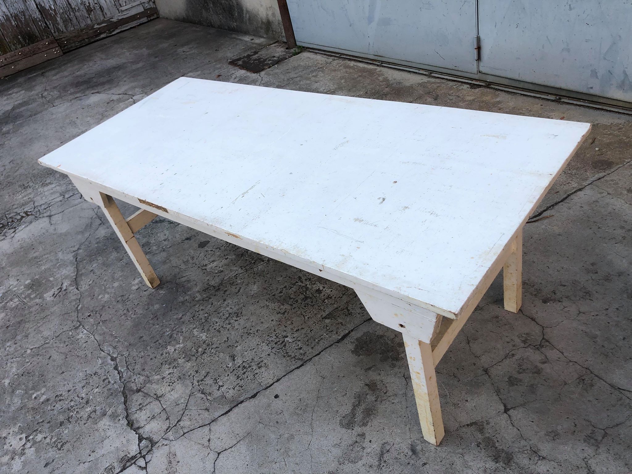 Old table in foldable wood painted white
