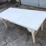 Old table in foldable wood painted white