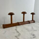 Wooden coat rack with three ball hooks.