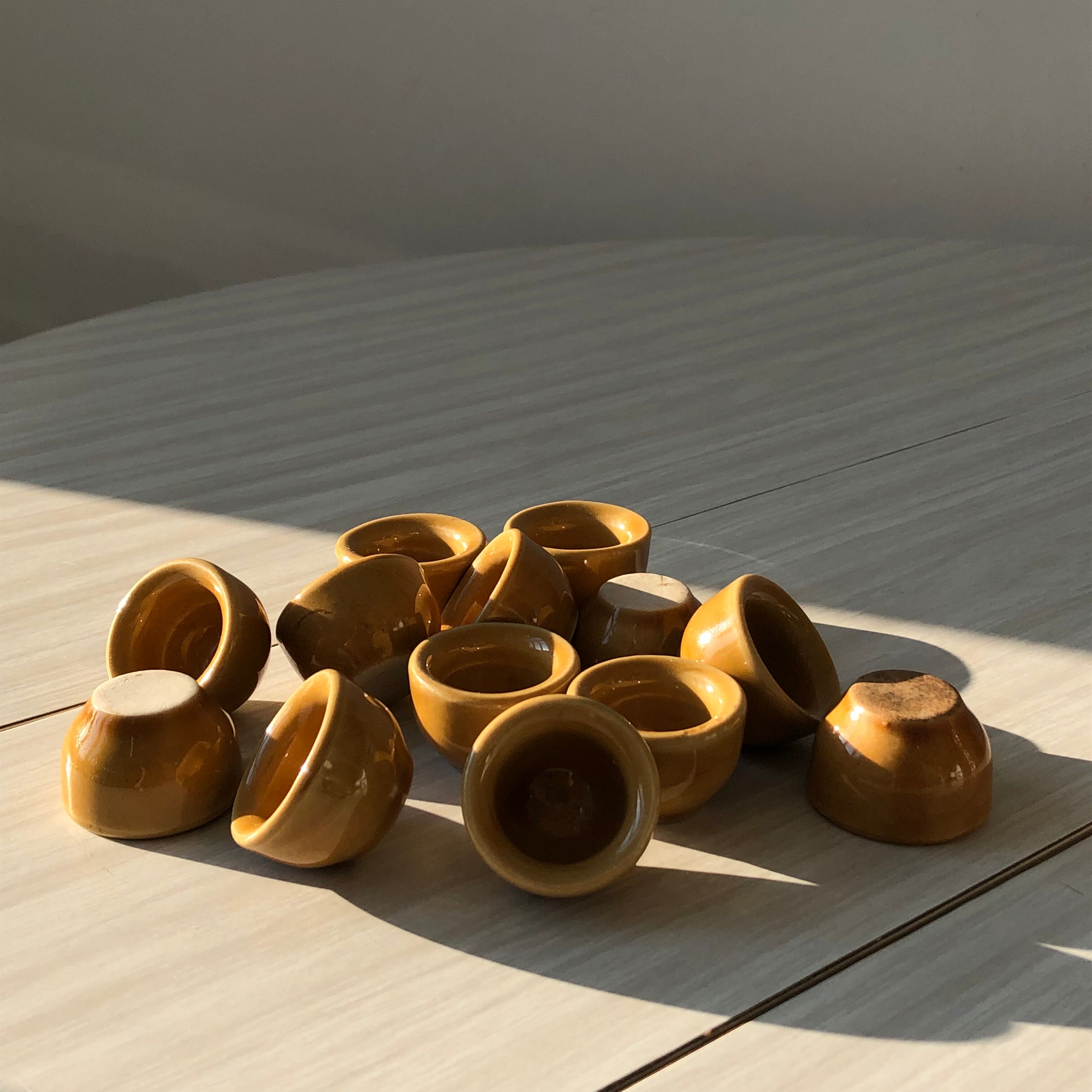 13 snail buckets or eggcups in fire porcelain glazed yellow-brown color