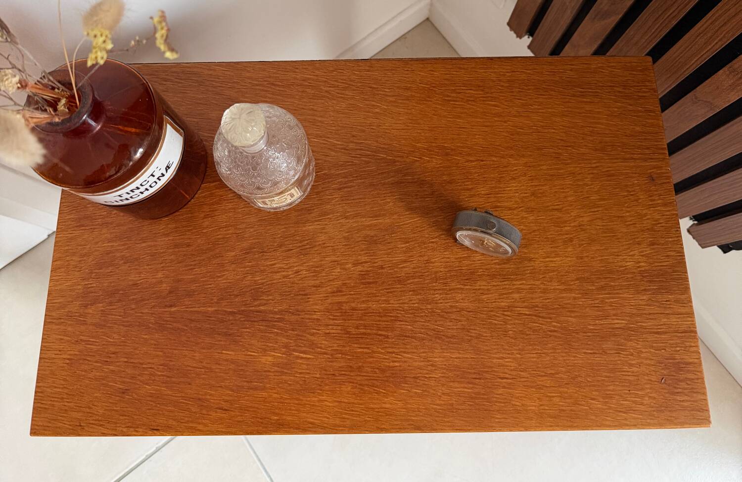 Vintage bedside table with tapered legs.