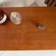 Vintage bedside table with tapered legs.