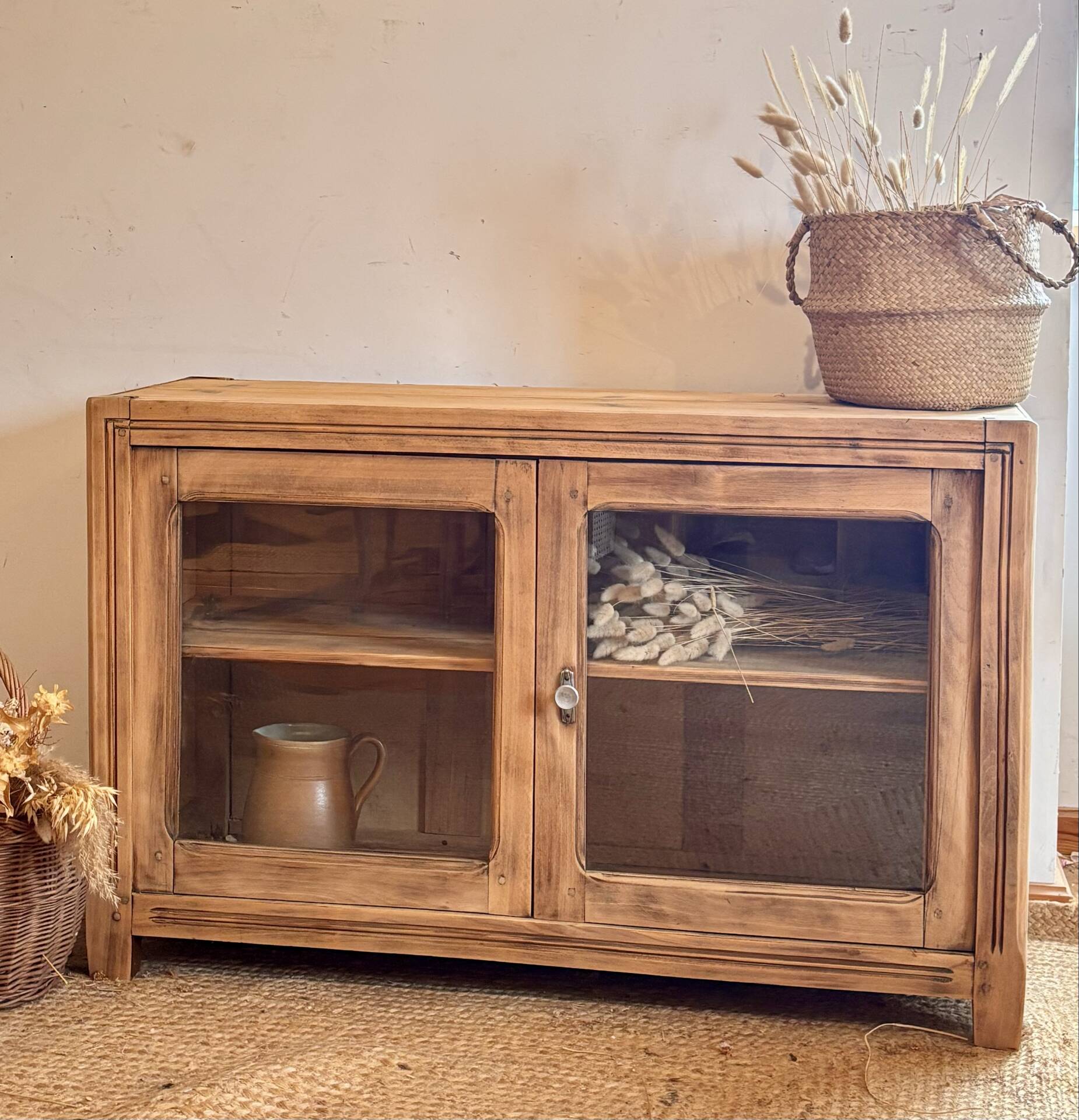 Old wooden buffet with a glass front in raw wood