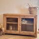 Old wooden buffet with a glass front in raw wood