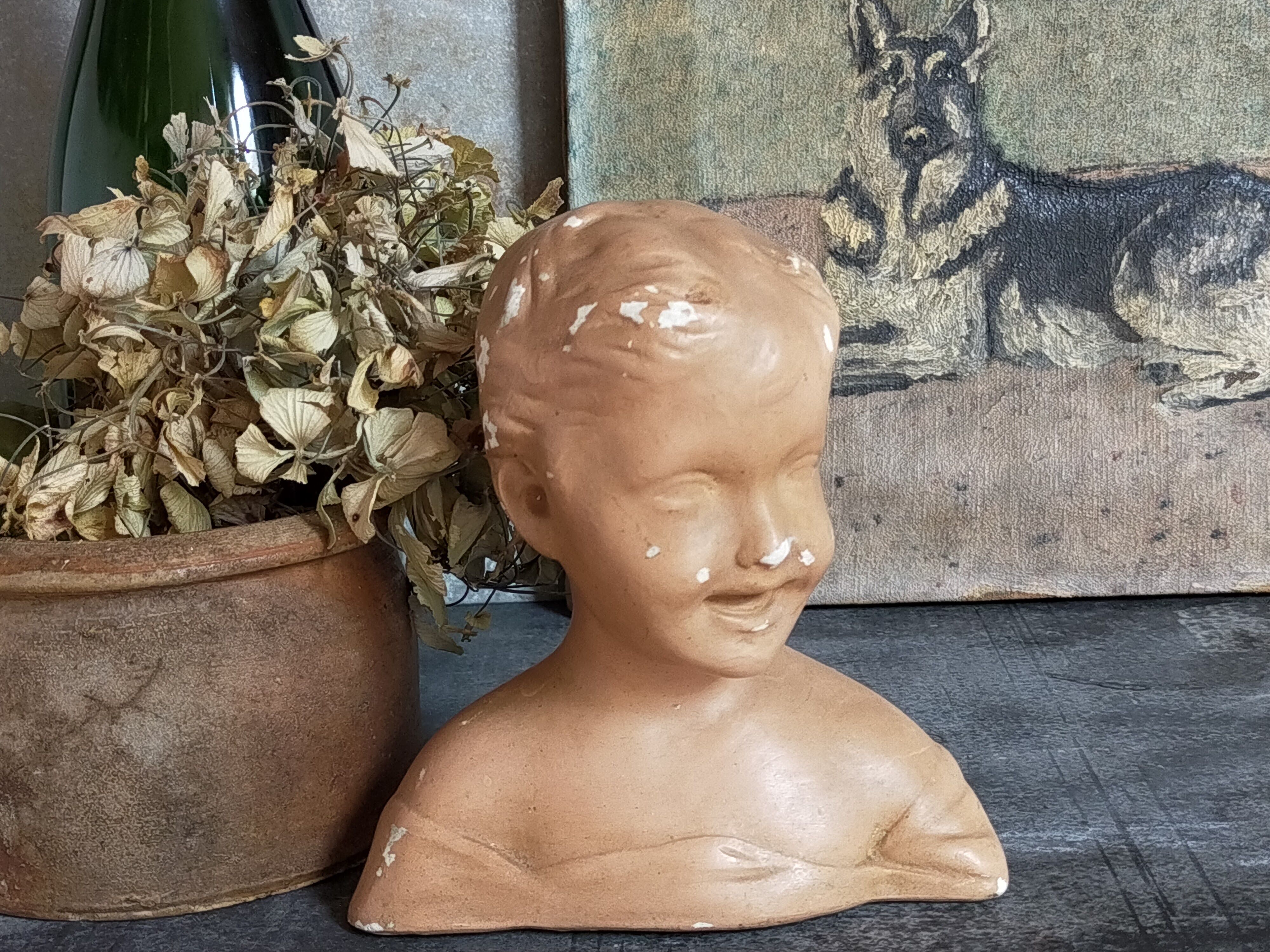 Bust of a small child in ancient plaster