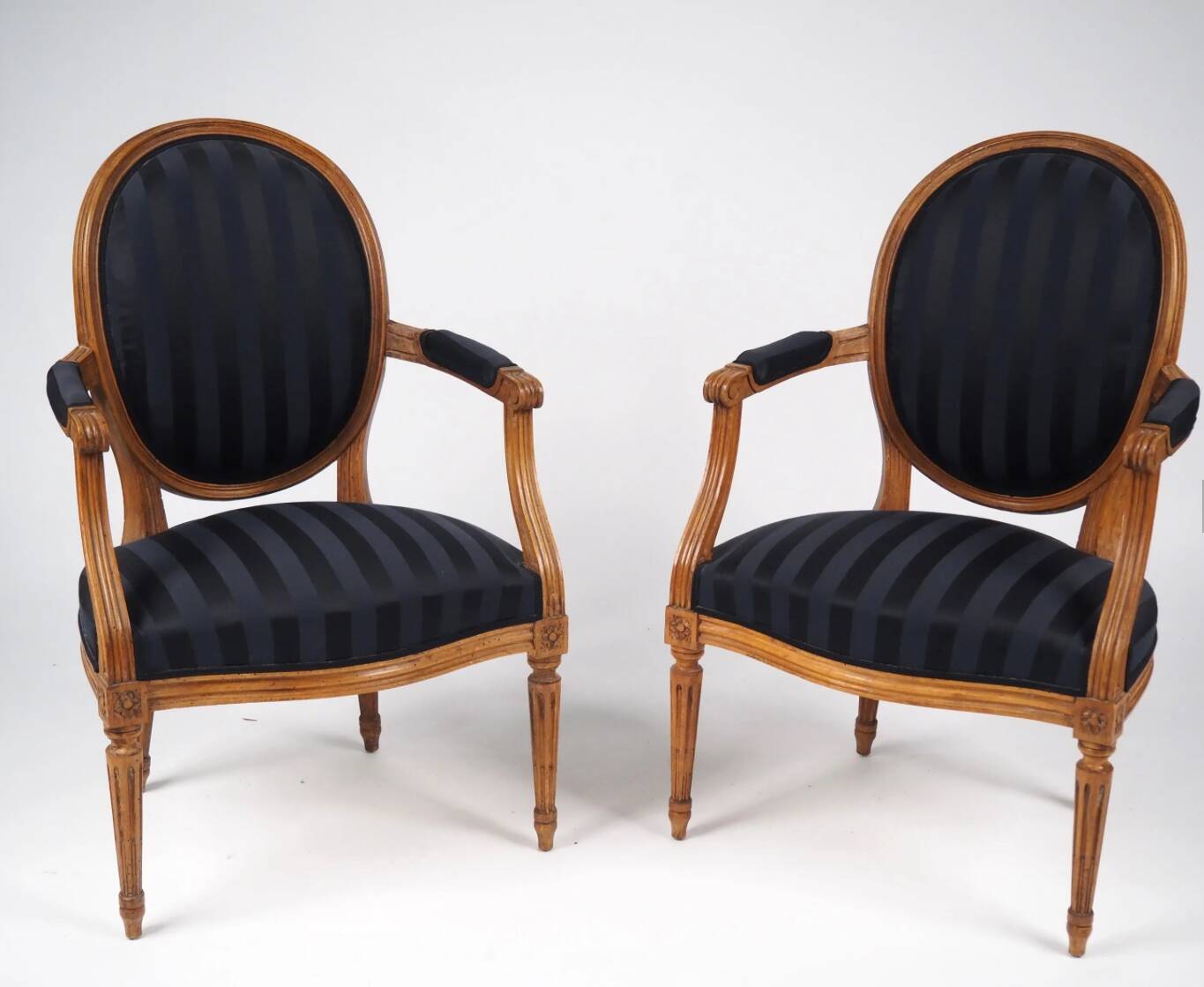 Pair of Louis XVI style cabriolet armchairs in natural wood.