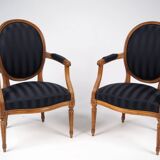 Pair of Louis XVI style cabriolet armchairs in natural wood.