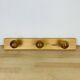 Wall coat rack with pine ball hook