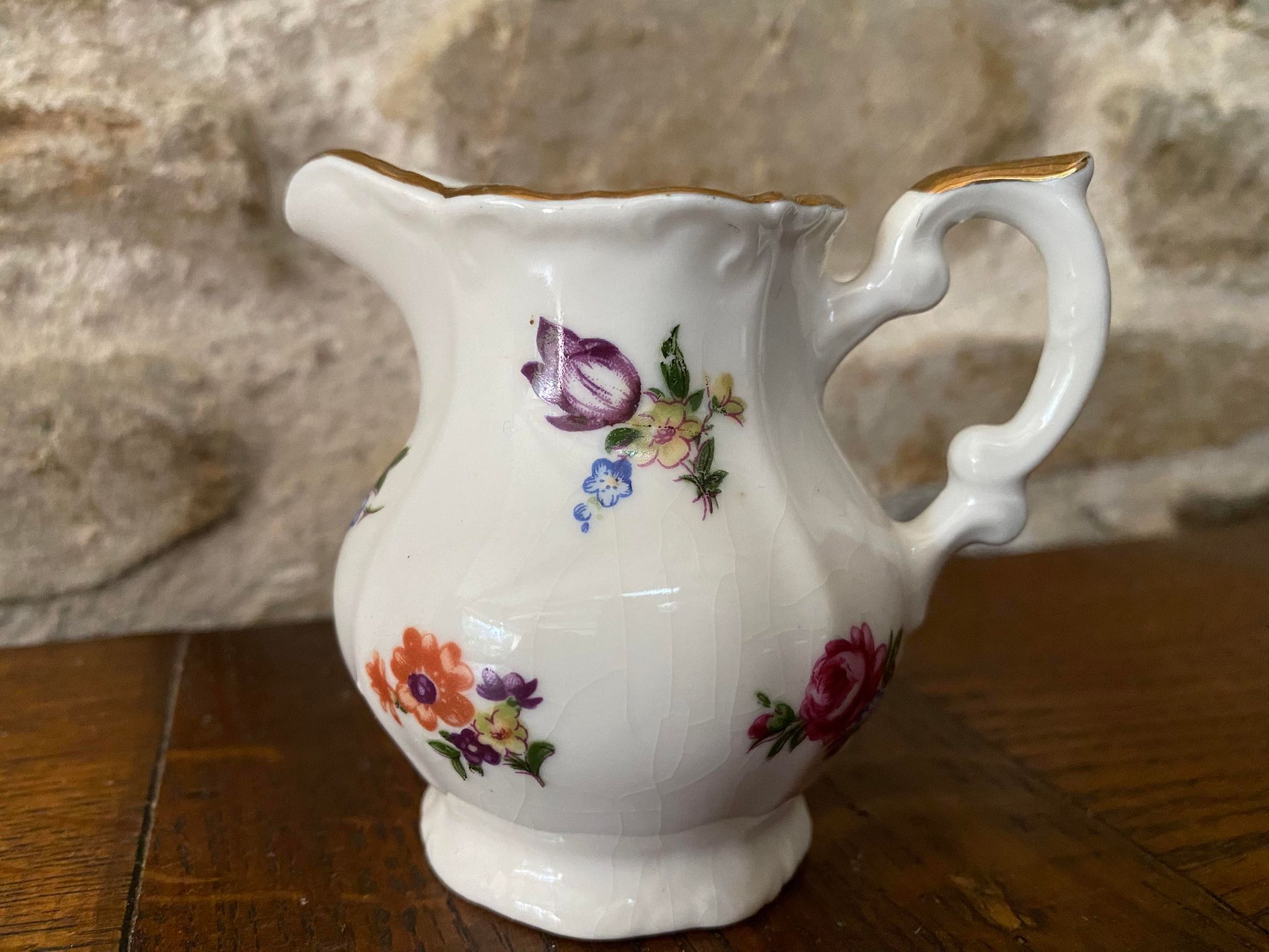 Small milk jug or creamer decoration flowers and golden edge