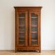 Louis XV style library in cherry wood with glass doors.