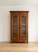 Louis XV style library in cherry wood with glass doors.