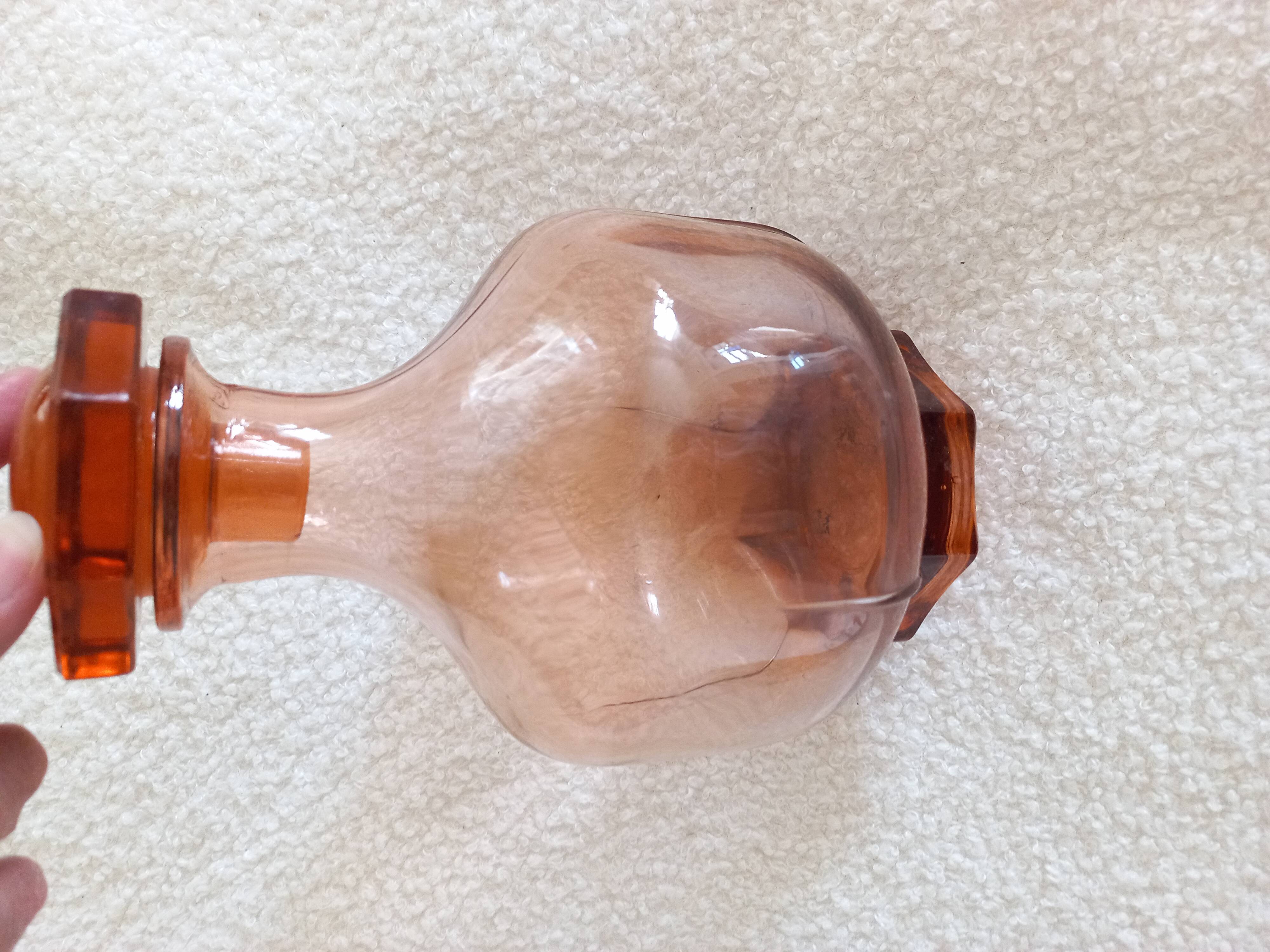 Vintage glass carafe in pink-orange, retro-chic style.